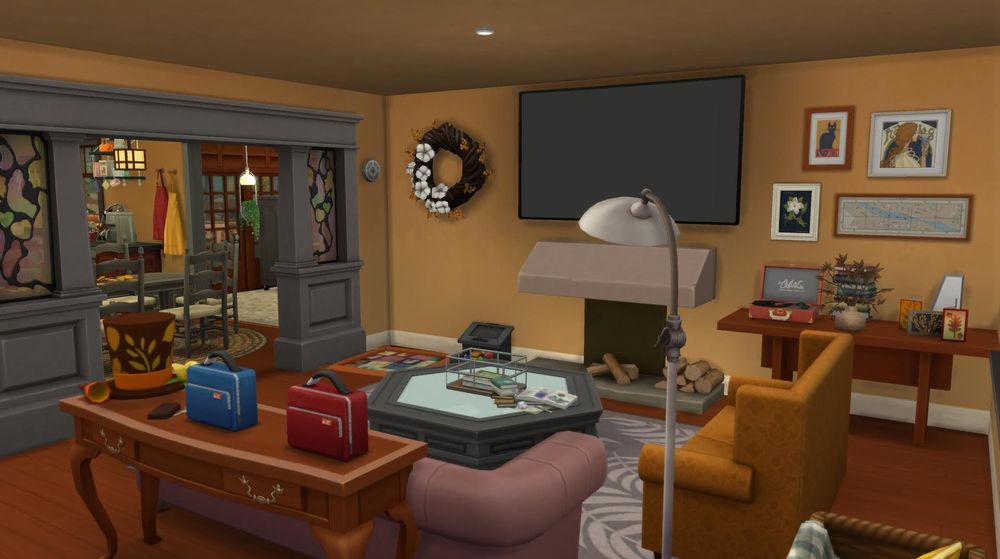The living room just inside the front door of the house. There is a snowy escape fireplace with a large TV above it. There are two vintage style couches with a hexagon shaped coffee table, that are in front of the fireplace. A big grey archway with stained glass leads to a dining room to the back left. A wreath on the wall, hat on the side table, and seasonal cards all decorate the room for fall.