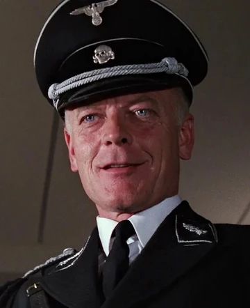 A Nazi with an SS hat with a totenkopf symbol on it