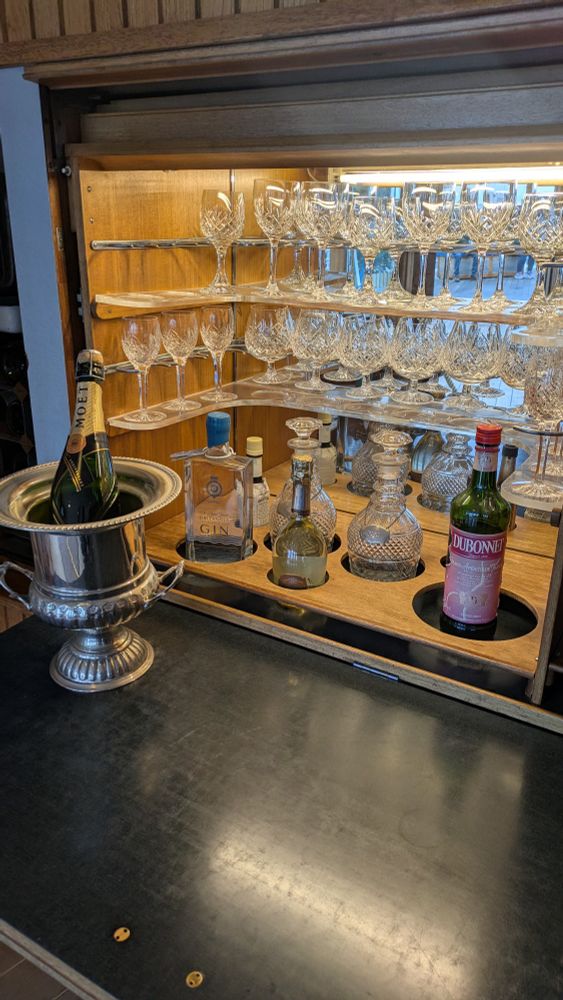 A bar with bottles of alcohol in the Queen's sitting Veranda near the grand deck aboard the Royal Yacht Britannia.