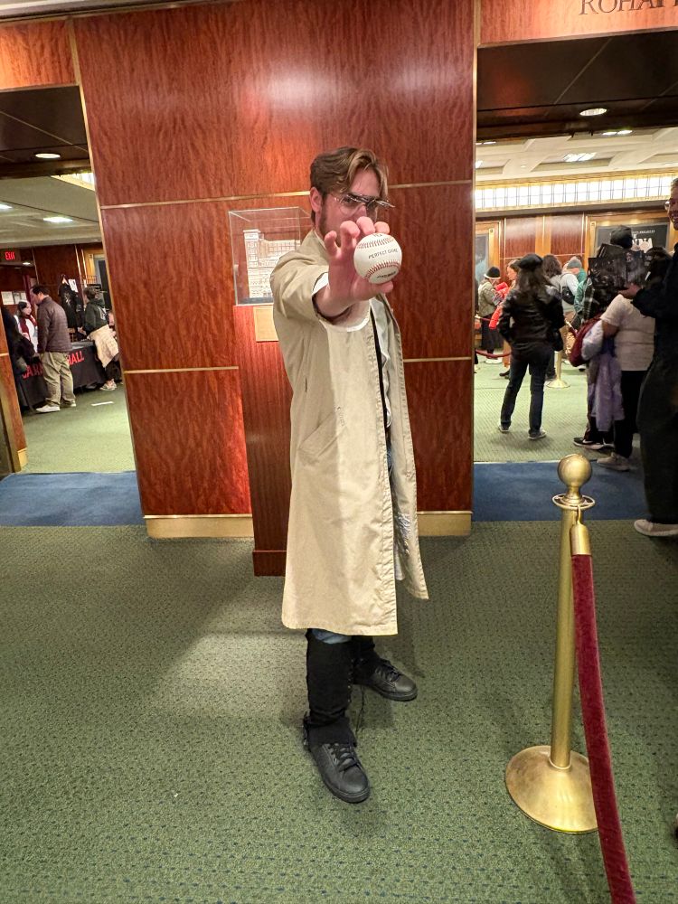 Image of Zeke Yeager cosplayer holding up a baseball with the words PERFECT GAME written on it.