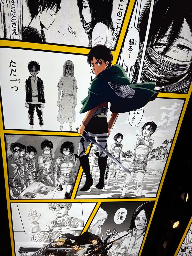 Attack on Titan collage on the ceiling of Akiba House featuring panels from the manga with an image of Eren Yeager, the series’s protagonist, from the anime in the center.