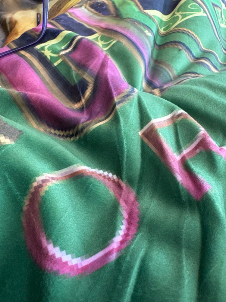 Close up of the Wicked For Good logo on the blanket looking very badly pixilated 