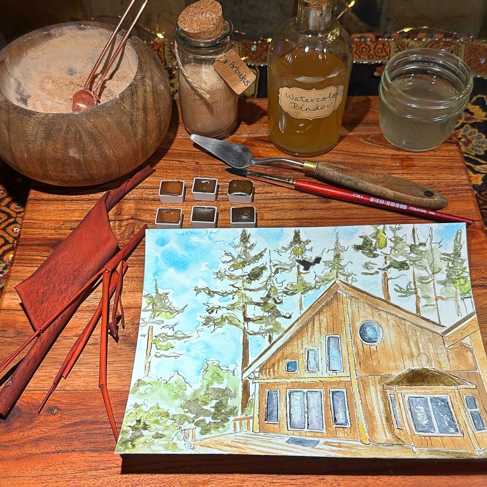 Watercolour painting on counter with paint making supplies, mortar and pestle, palette knife, glass jar, paint brush. 