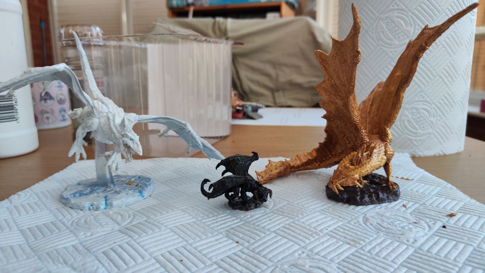 White, black and gold dragon miniatures