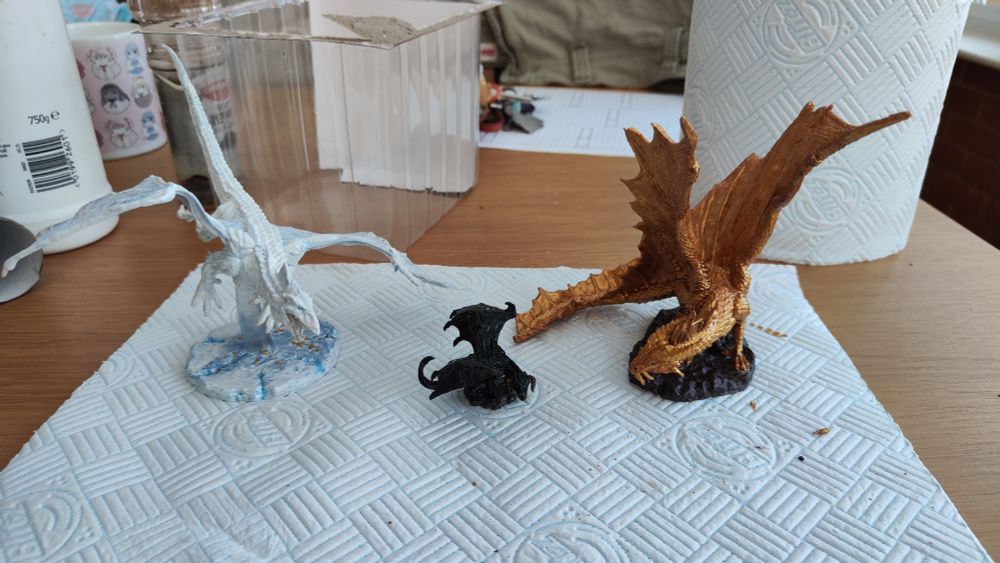 White, black and gold dragon miniatures