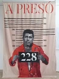 Una lona con la imagen de Mazón vestido de presidiario, sosteniendo un cartel con el número 228 (por las víctimas de la Dana), y que reza "A Presó" en su encabezamiento