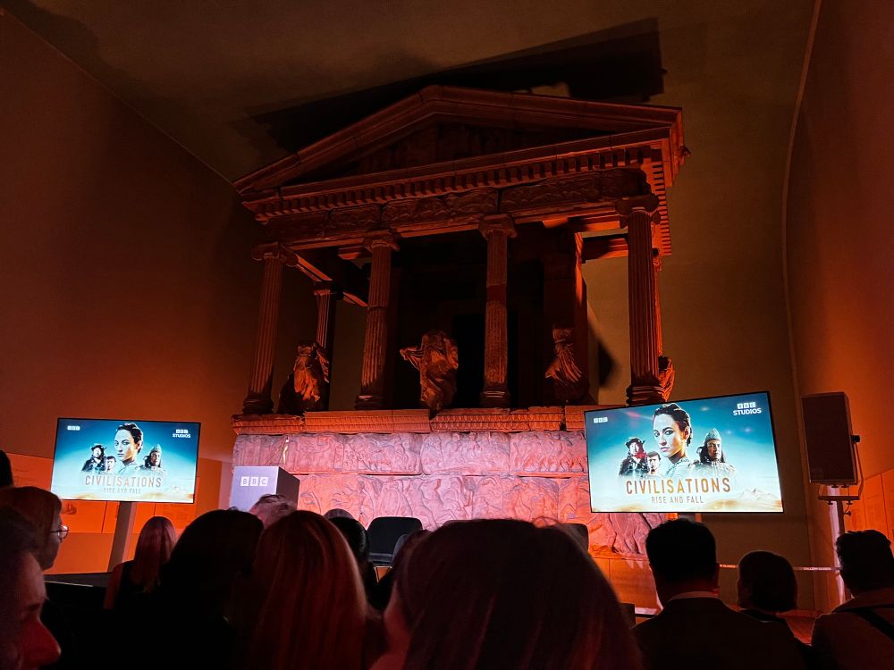 Two screens against a beautifully lit archaeological backdrop