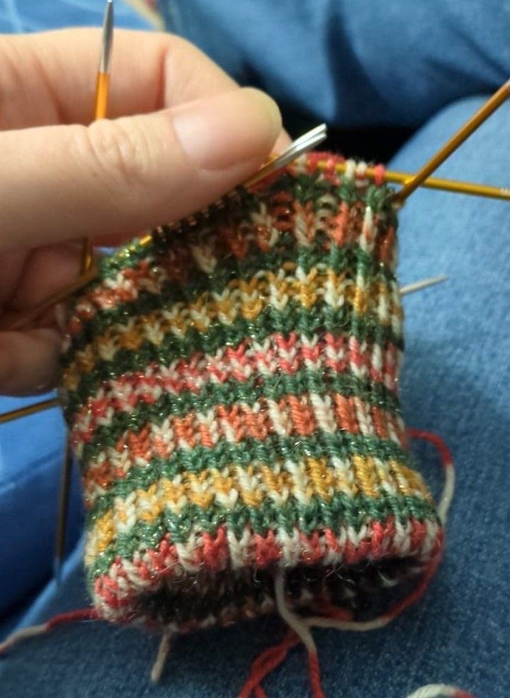3 inches of twisted rib knitted in Christmas themed self striping yarn for the cuff of a glove. 