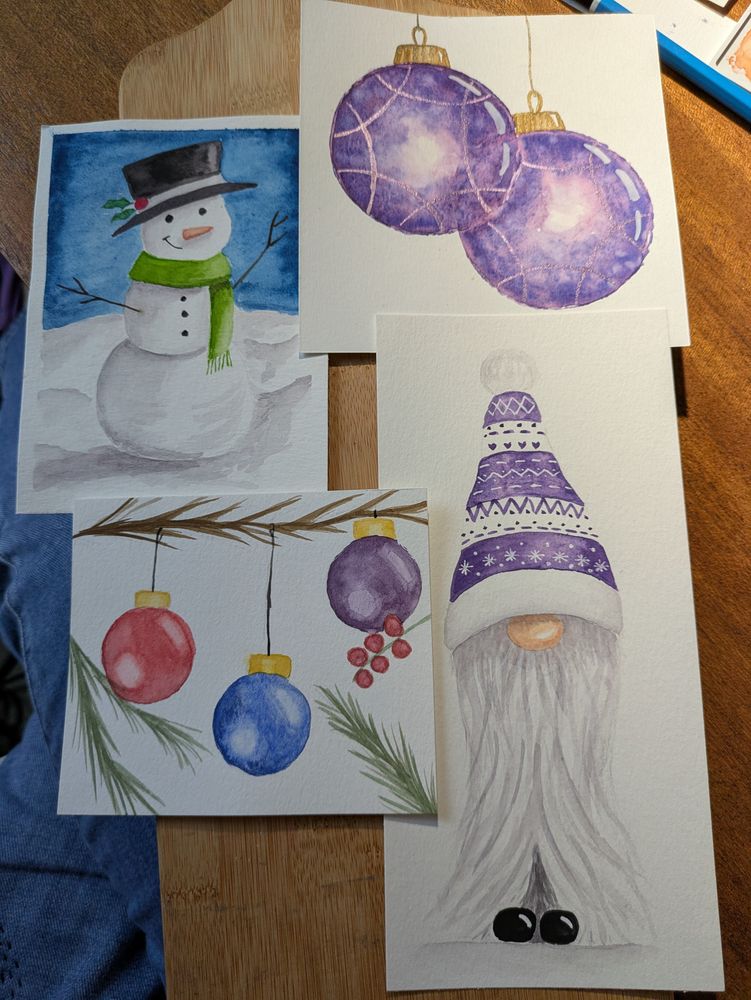 Four watercolour card fronts. One snowman, one gonk, and two with hanging spherical ornaments. 
