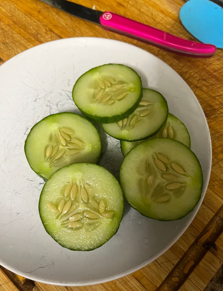 Slices of cucumber on a white plate 