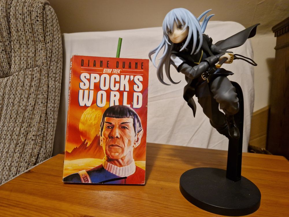 A copy of the novel Spock's World by Diane Duane and a figurine of Rimuru Tempest from That Time I Got Reincarnated as a Slime 