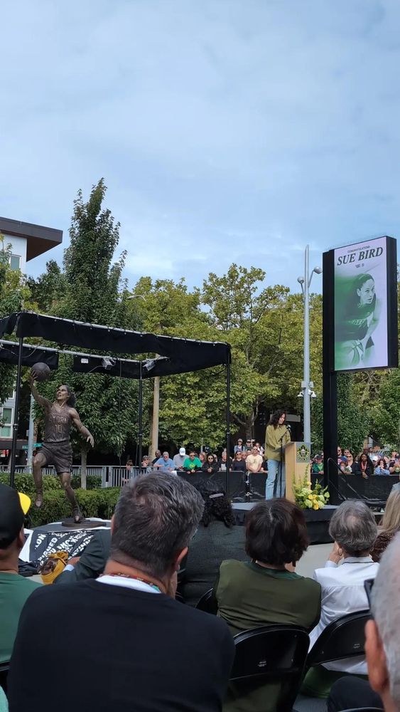 Seattle Storm legend Sue Bird speaks next to her recently unveiled bronze statue. 