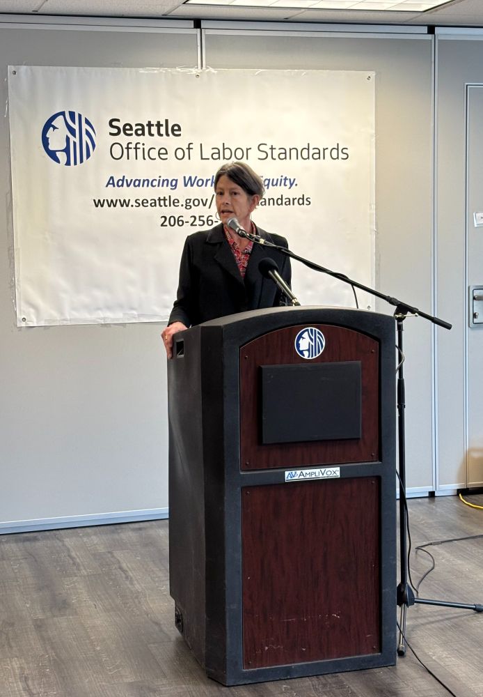 Council President Nelson speaking at a lectern. 