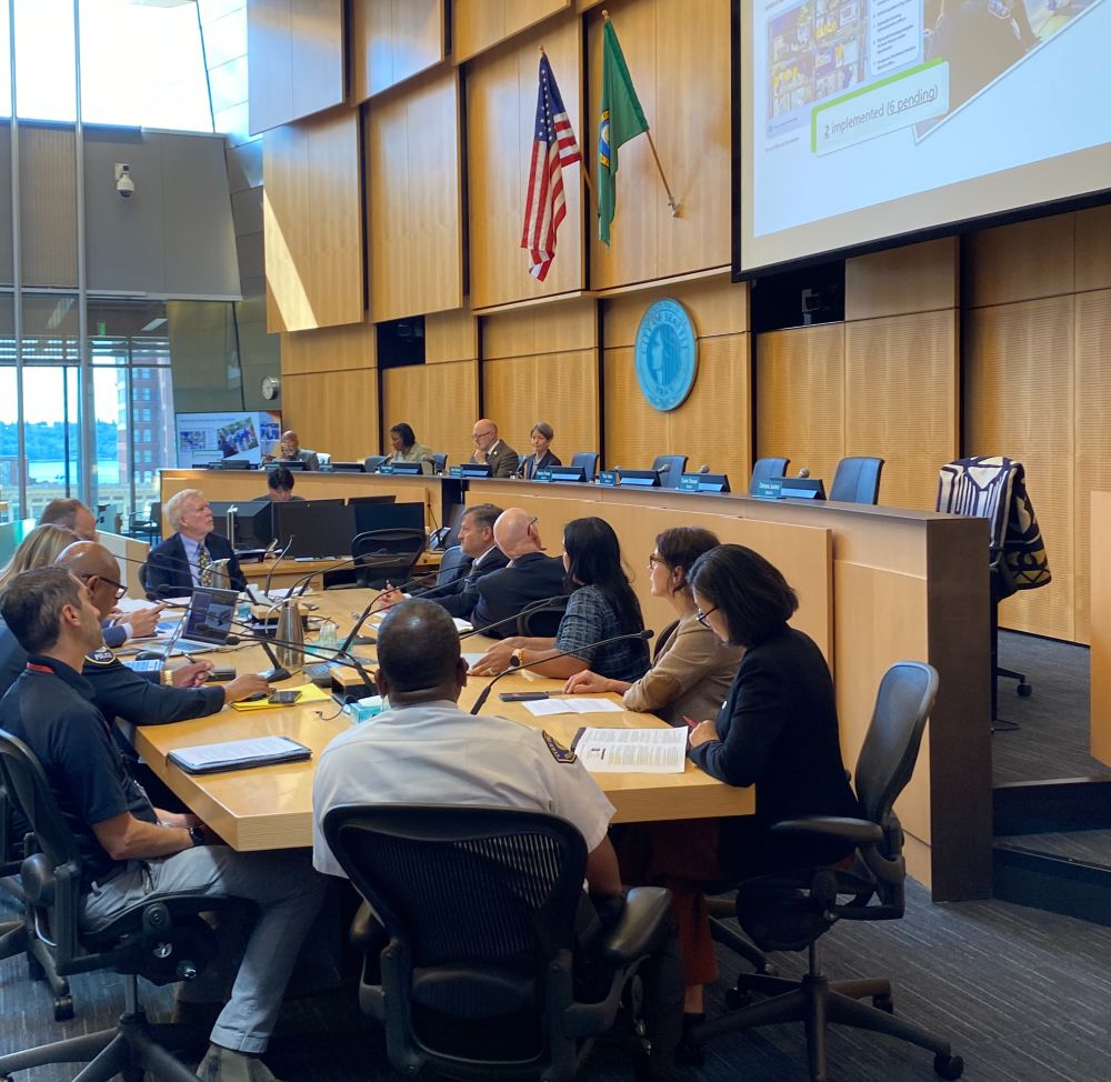 Seattle public safety leaders seated at a conference table in front of City Council committee members. 