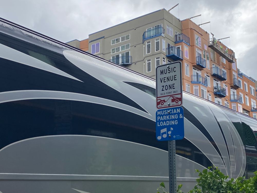 A sign on a pole that reads "Music Venue Zone, Musician Parking & Loading" 