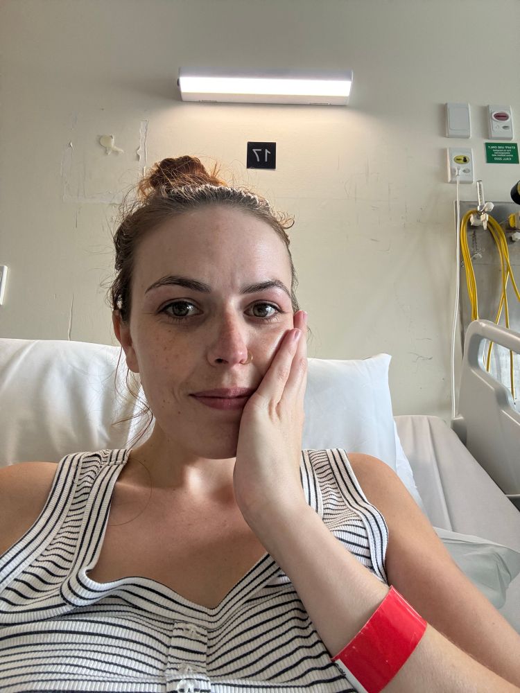 Girl smiling in hospital after having nasal gastric tube removed. 