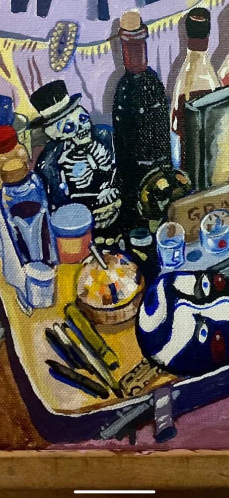 A closeup of the image featuring the details of the mask & disco ball cup along with a skeleton snow globe and various bottles. 