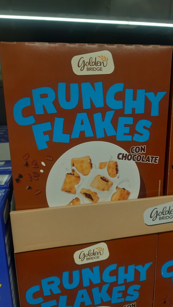 Aldi cereal box for crunchy flakes with blue text and a brown background.