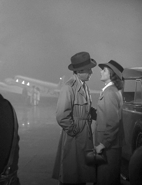 Humphrey Bogart and Ingrid Bergman stand on a foggy airfield in the film "Casablanca."