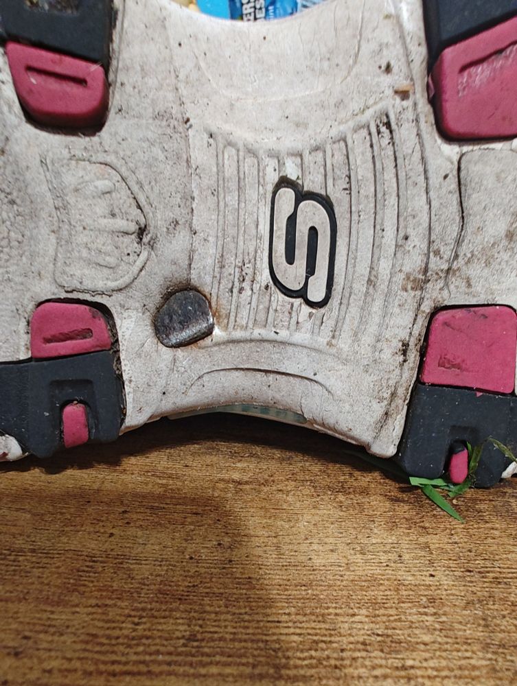 It looks like the head of a tack in the bottom of a sneaker.