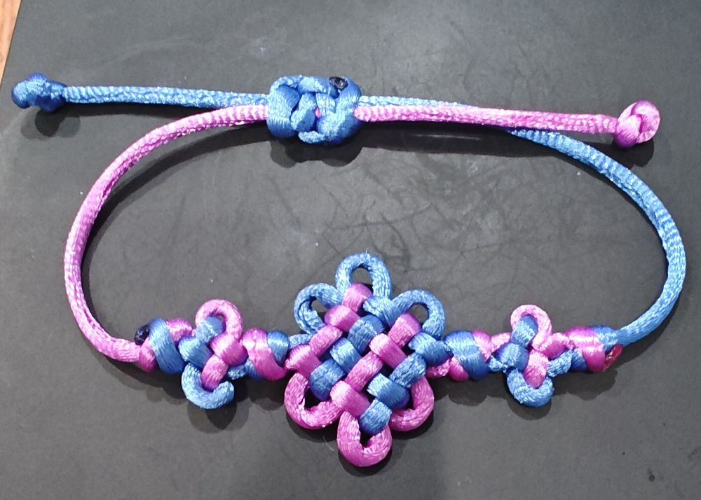 A bracelet knotted to look like the one from Kpop Demon Hunters