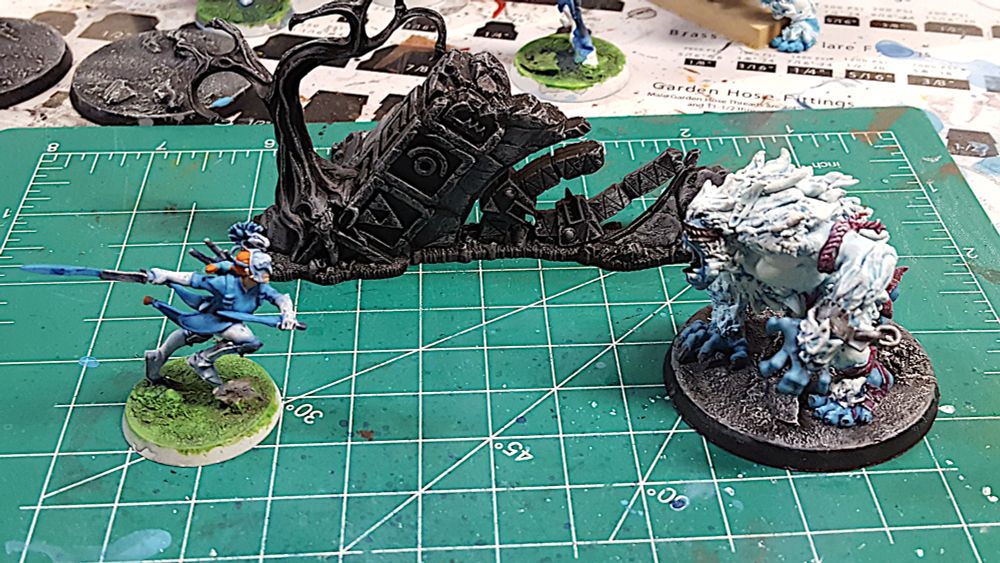 An elf with two swords faces off against a screaming yeti.