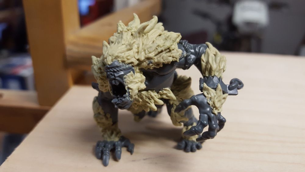 A roaring orge covered in epoxy hair painstakingly hand-sculpted.