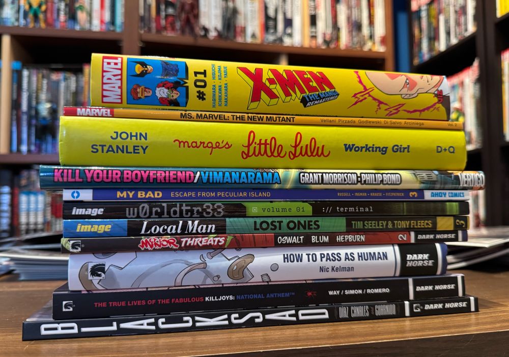 A stack of various comic books