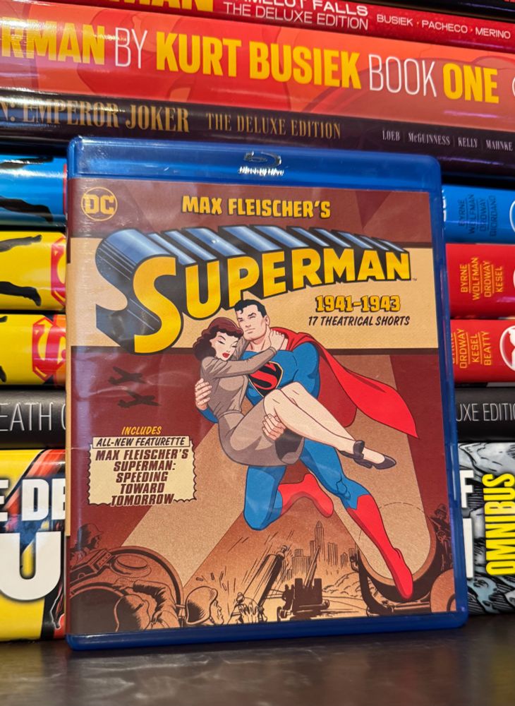 A Blu-ray of Max Fleischer’s Superman in front of a stack of Superman comics 