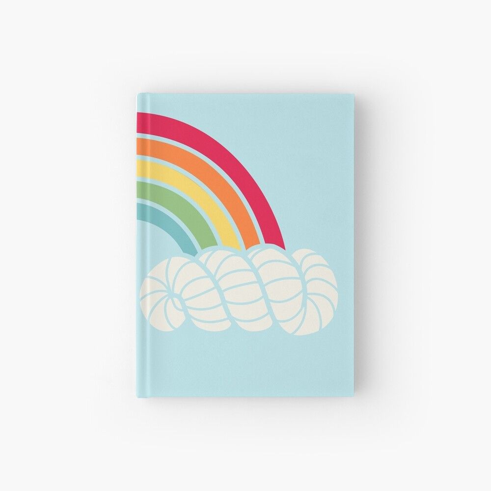 Product mockup of a lightblue hardcover journal, showing just the front. The cover depicts a vector illustration of a rainbow coming out of white hanks of yarn that wraps around the spine to the back. The hanks of yarn represent clouds.