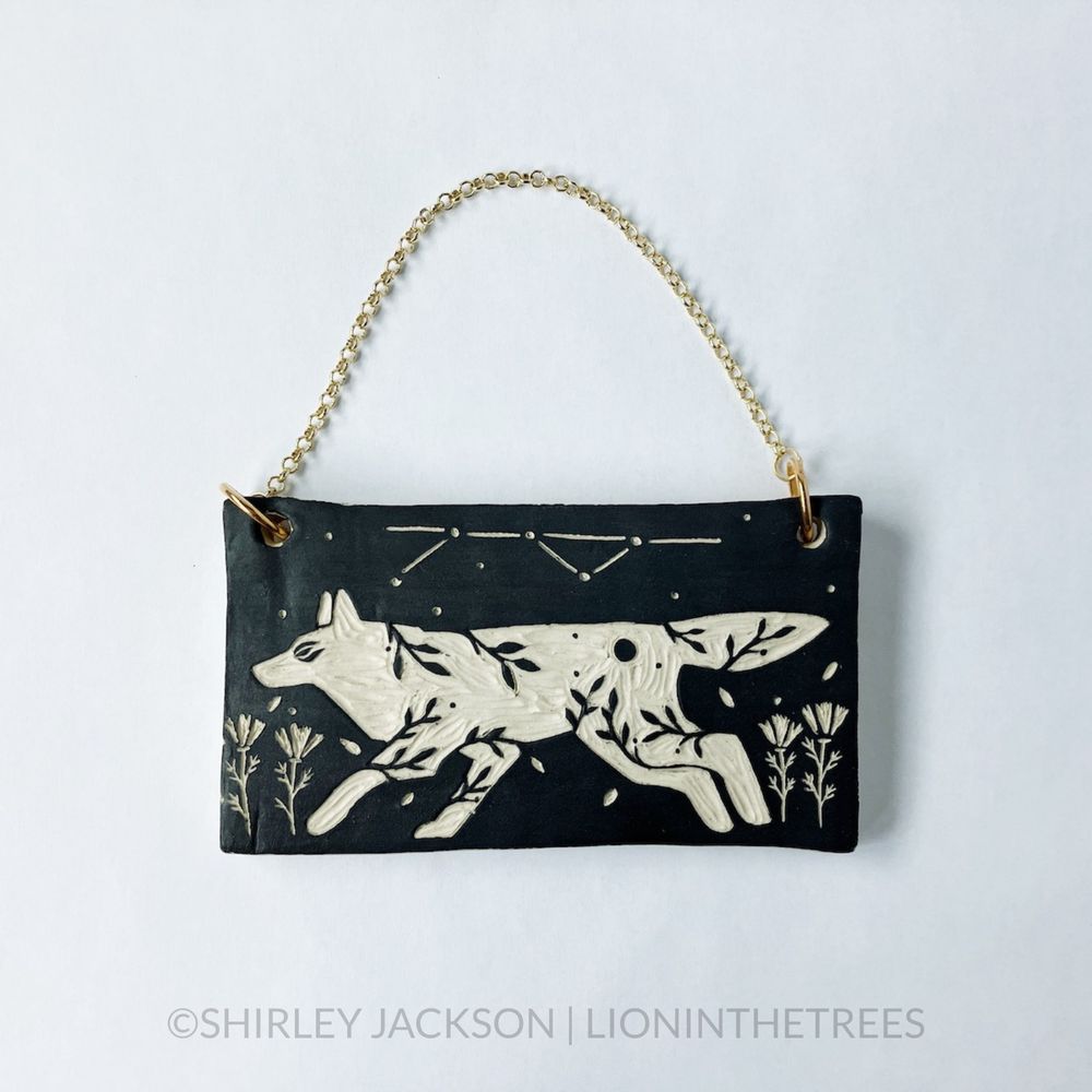 Ceramic black sgraffito wall slab featuring my Running Wolf motif