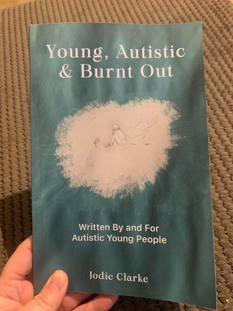 Green book with drawing of a child huddled up