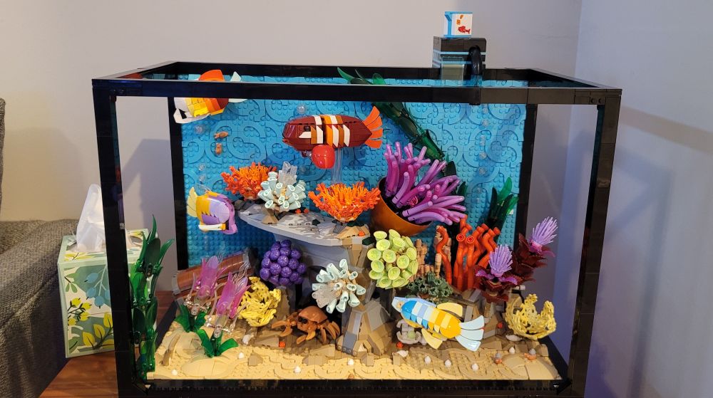 Front view: Lego tropical aquarium fully built,  featuring an assortment of coral and brightly colored fish