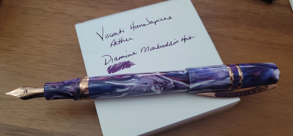 Visconti HS Aether fountain pen (purple, pink, and white swirls) inked with diamine monboddos hat (purple) on white mottainai memo paper