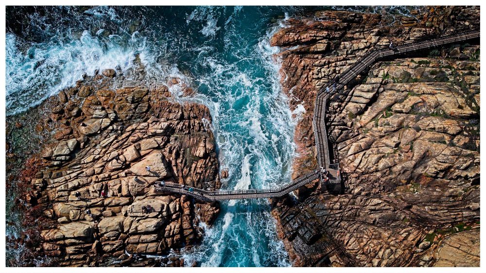 A drone shot of the Canal Rocks from above, showing the bridge and path leading to it.