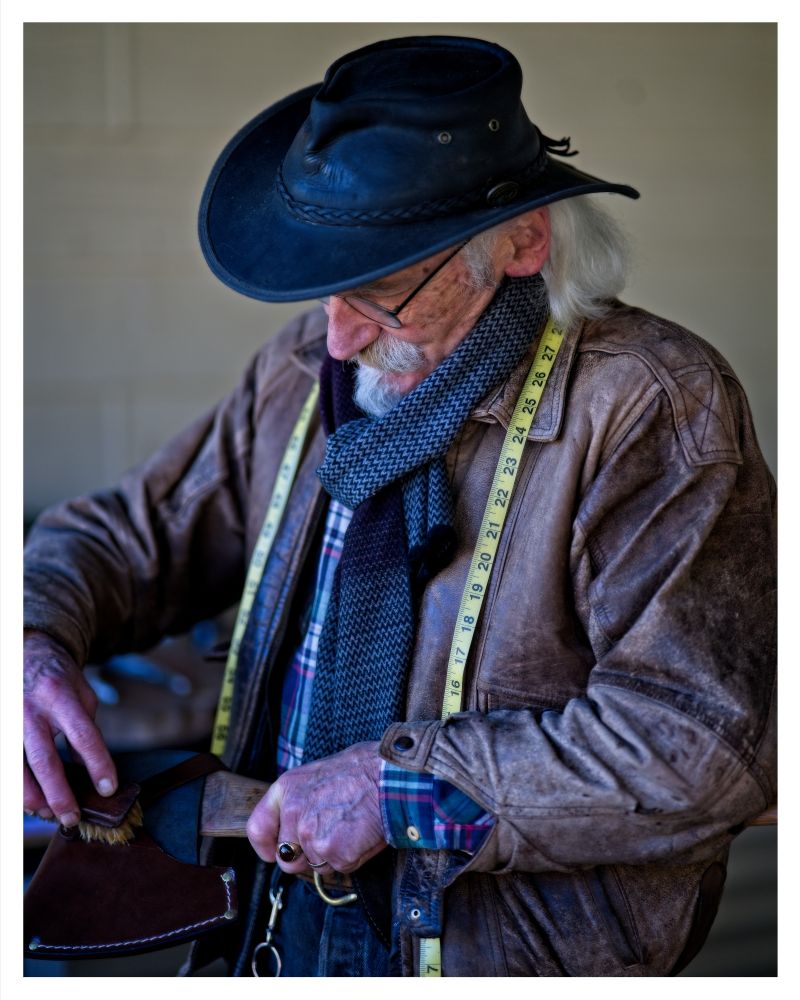 A stallholder works on his leather goods