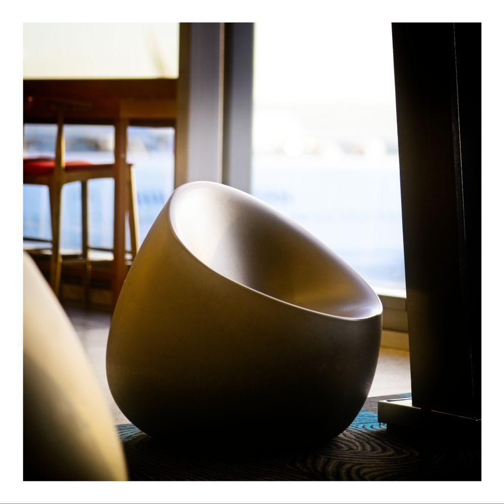 An empty chair at the airport in the late afternoon sunlight