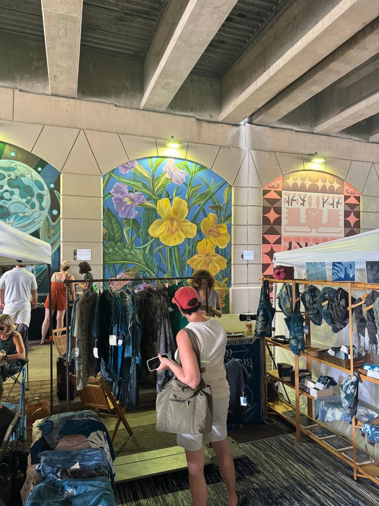 A person shopping in front of the mural