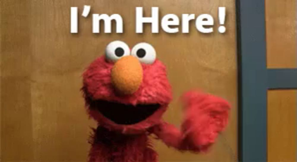 elmo from sesame street is standing in front of a door and says i 'm here