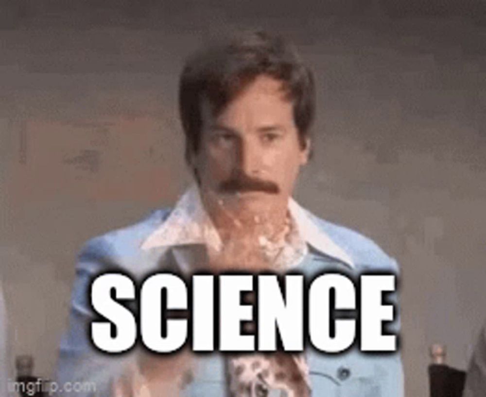 a man with a mustache is holding a piece of paper with the word science written on it .