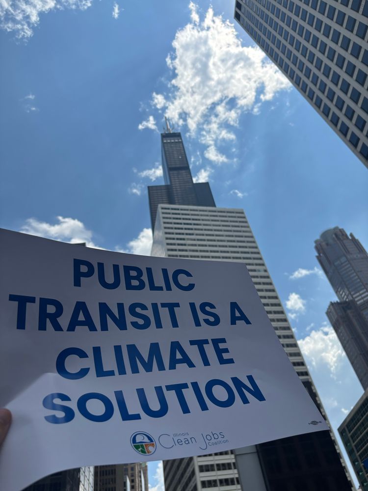 Sign displaying the message “public transit is a climate solution” in front of the Willis/Sears Tower in Chicago. 