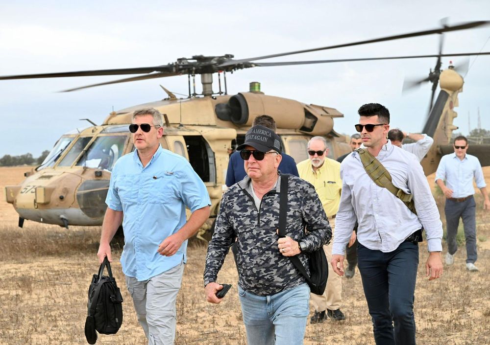 US special envoy Steve Witkoff and American ambassador to Israel Mike Huckabee walk in Gaza with a team of staffers and a helicopter in the background