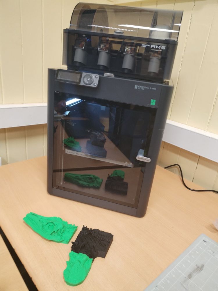 A AMS 3D printer with parts of ichthyosaurus freshly printed 
