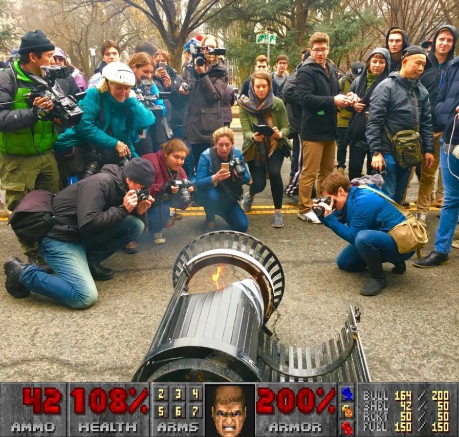 the photo of everyone taking a photo of the flaming trash can but the doom hud is beneath it so it looks like the trash can is a gun