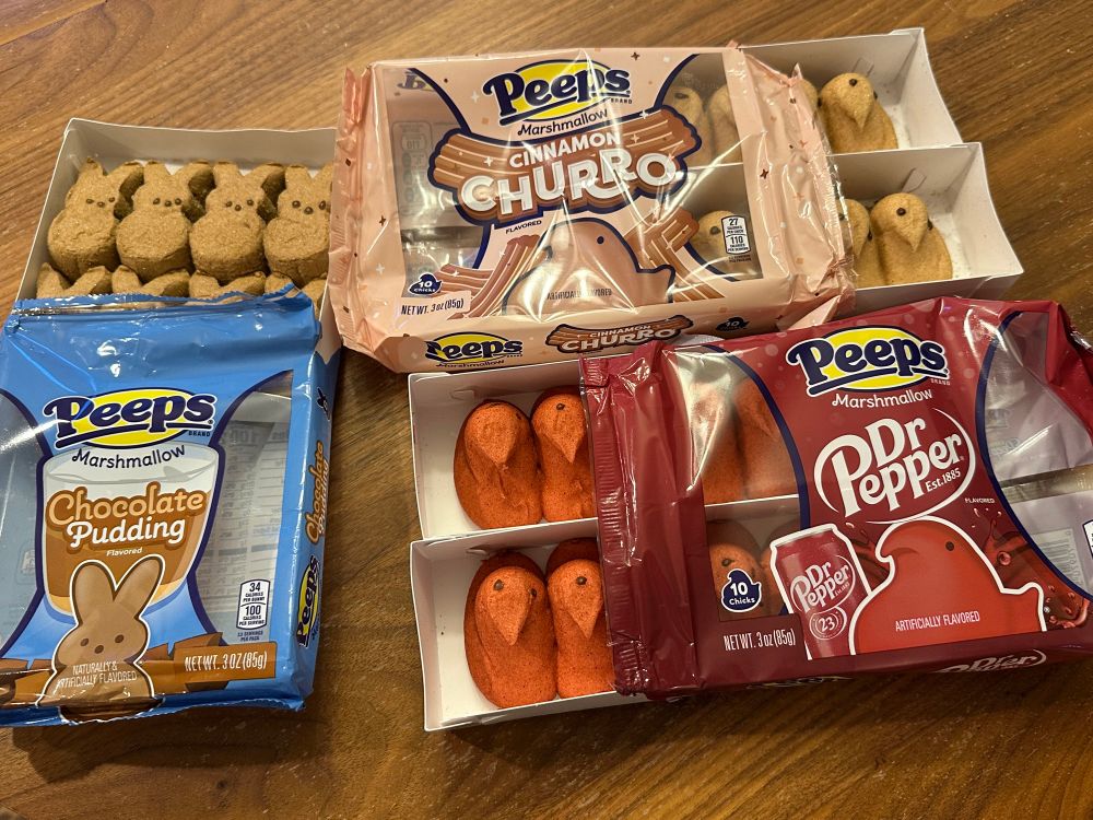 Three packages of peeps -  chocolate pudding, Dr Pepper, and churro flavors