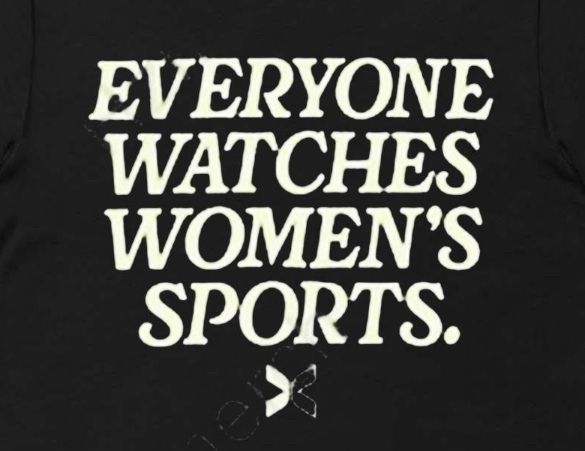 Picture of the front a black shirt with cream writing that says, “Everyone Watches Women’s Sports” 