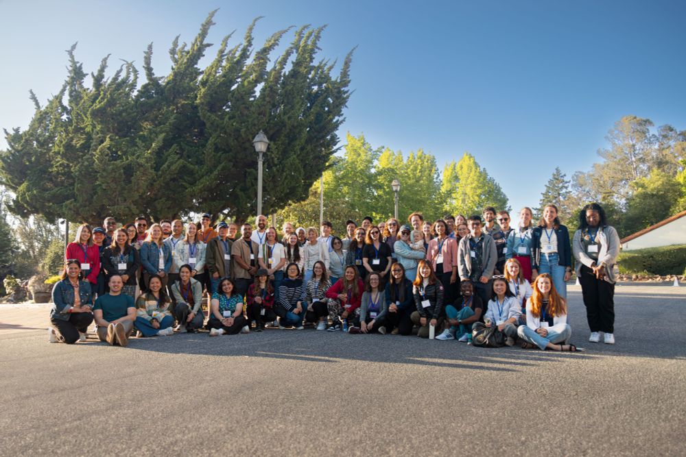 A group of UCSF researchers gathered for a photo in front of the Chaminade Resport & Spa at sunset.