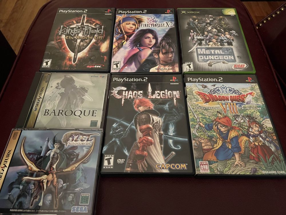 photo of seven retro video games. Top row: King's Field 4 The Ancient City (PS2), Final Fantasy X-2 (PS2), Metal Dungeon (Xbox)
Bottom Row: Baroque (Sega Saturn), Chaos Legion (PS2), Dragon Quest 8 Japanese Version (PS2)
Bottom left: Azel - Panzer Dragoon RPG (aka Panzer Dragoon Saga) (Sega Saturn)