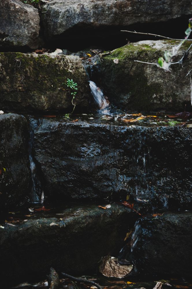 Water flows down large rocks. Taken with a Nikon D40