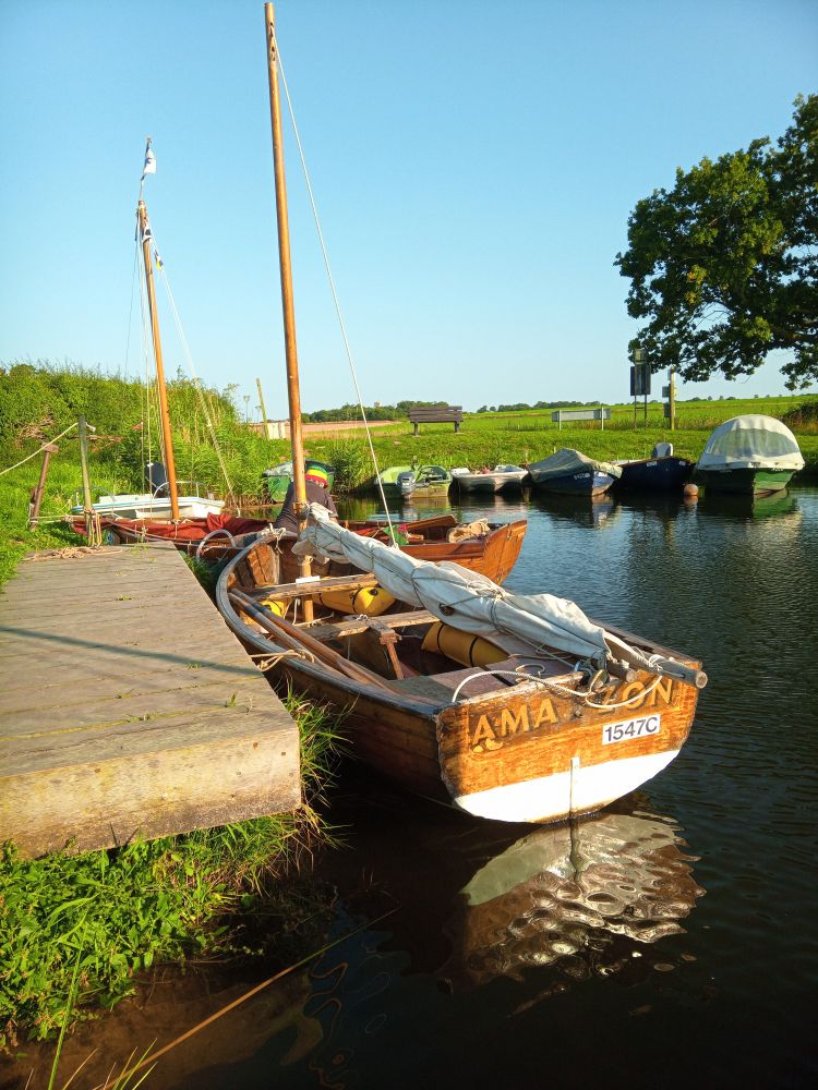 Clinker dinghy Amazon, from the '63 BBC series /and/ '74 film of Arthur Ransome's 'Swallows and Amazons', moored up in front of Swallow, here in everso flat Norfolk.

